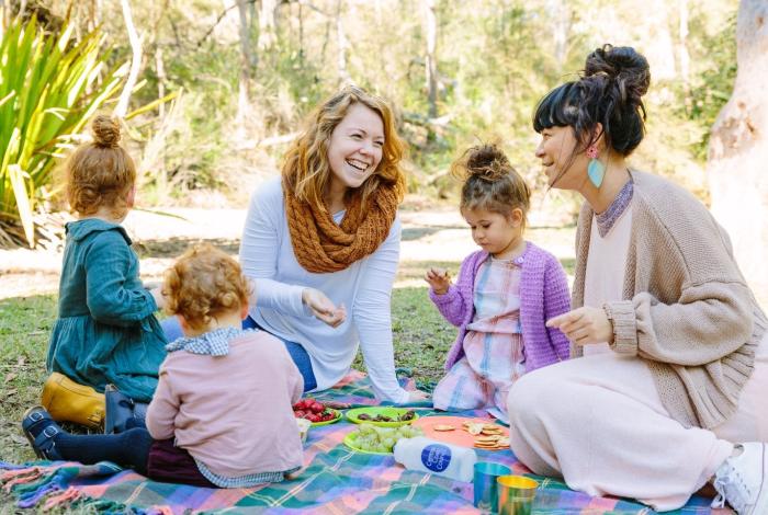 Photo of 2 adults and 3 children having a picnic